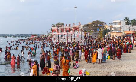 Devotees taking bath in the sea before going to the Temple at Rameswaram Beach, Tamilnadu, India. Stock Photo