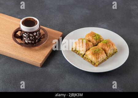 Traditional pistachio baklava with Turkish coffee Stock Photo