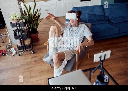 Asian man wearing virtual reality device while pointing by hand Stock Photo