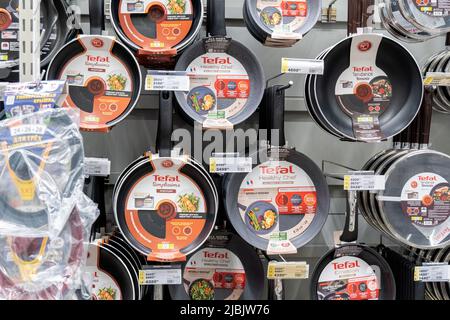 Tyumen, Russia-April 14, 2021: Tefal frying pan display in a large hypermarket. Sale of kitchen utensils Stock Photo
