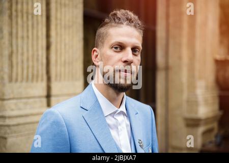 Caucasian man in blue three piece suit, outdoor portrait Stock Photo