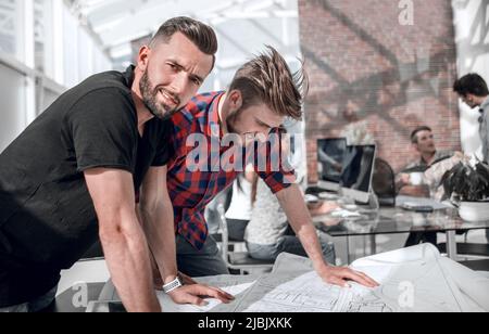 employees of the project office, standing at the workplace Stock Photo