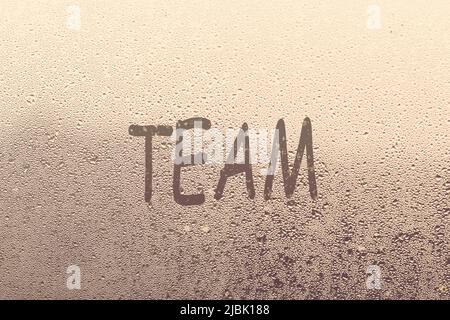 team word written on a window with raindrops Stock Photo