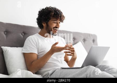 Happy eastern man having online party with friends Stock Photo