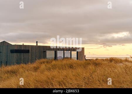 facade of a designer building made of wood on the seashore. Stock Photo