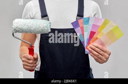 close up of painter with roller and color charts Stock Photo