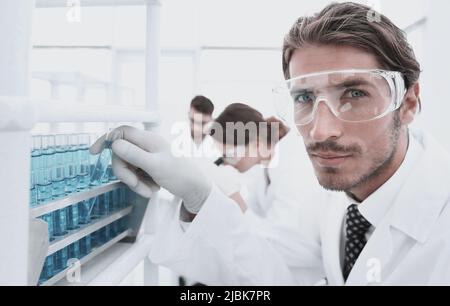 man in goggles to check fluid in vitro. Stock Photo
