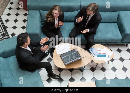 Mixed raced business man feeling happy reward bonus, celebrates financial market growth concept happy friendly multiracial coworkers group having fun Stock Photo