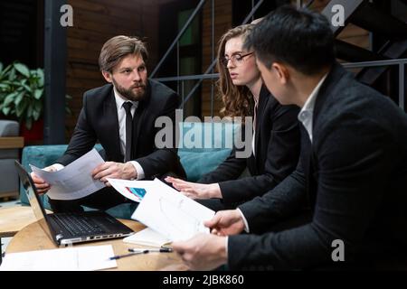 Multinational business people group brainstorm at office meeting. Multiethnic professional employees team talking engaged in teamwork discussing impro Stock Photo