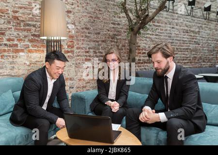 Multinational business people group brainstorm at office meeting. Multiethnic professional employees team talking engaged in teamwork discussing impro Stock Photo