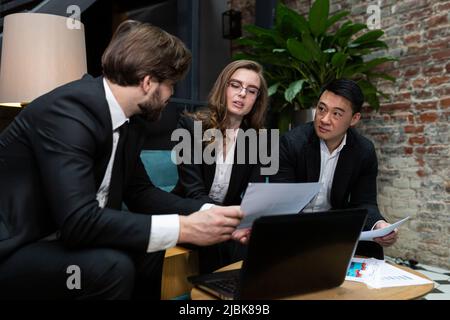 Multinational business people group brainstorm at office meeting. Multiethnic professional employees team talking engaged in teamwork discussing impro Stock Photo
