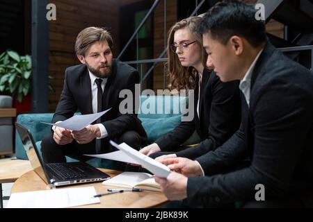 Multinational business people group brainstorm at office meeting. Multiethnic professional employees team talking engaged in teamwork discussing impro Stock Photo