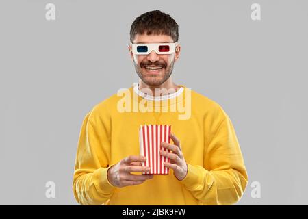 happy man 3d movie glasses with popcorn in bucket Stock Photo