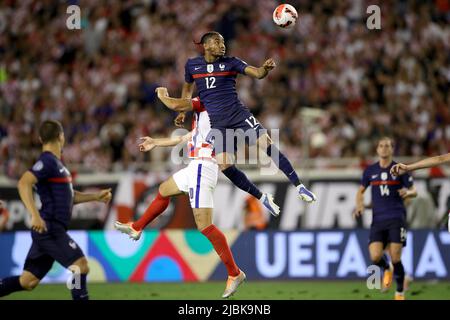 Split, Croatia. 6th June, 2022. Christopher Nkunku (top) of France vies for the ball during the UEFA Nations League League A Group 1 football match between Croatia and France at Stadion Poljud in Split, Croatia, on June 6, 2022. Credit: Igor Kralj/PIXSELL via Xinhua/Alamy Live News Stock Photo