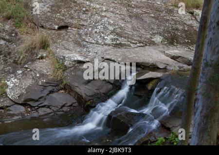 Waterfall among the rocks Stock Photo