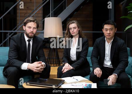 Male businessman in black business suit uses virtual reality goggles, to view economic information, and for online conferences Stock Photo