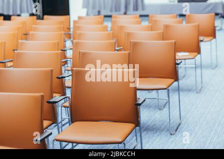 large empty conference room with orange chairs before the auction Stock Photo