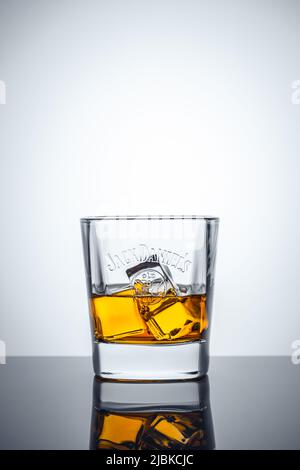 Glass of scotch whiskey and ice cubes on a white background. Whisky Jack Daniel's. Brand of the best selling American whiskey in the world. Illustrati Stock Photo