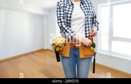 woman or builder with working tools on belt Stock Photo