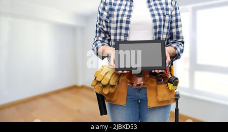 woman builder with working tools showing tablet pc Stock Photo