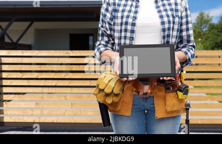 woman builder with working tools showing tablet pc Stock Photo