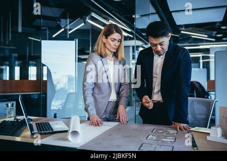 professional architect designer structural engineer team colleagues working office looking computer screen discussing building plan design project dra Stock Photo