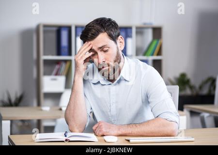 Close-up portrait of pensive man in office, businessman thinking over decision Stock Photo