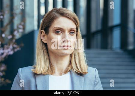 Close-up photo of a confident business woman looking at the camera thoughtfully and seriously Stock Photo