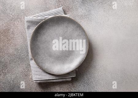 Empty gray plate and on gray background. View from above.Flat lay. Copy space. Template or mockup for your meal. Stock Photo
