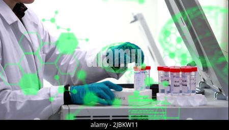 Image of chemical formulas and data processing over caucasian male lab worker with samples Stock Photo