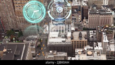 Image of snow falling, moving clock and scope scanning over cityscape Stock Photo