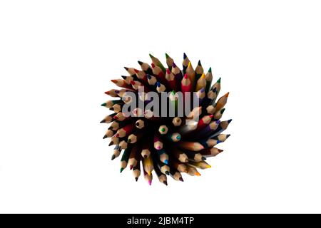 Top view of a bunch of sharpened color pencils standing in a pencil holder isolated on a white background. Stock Photo