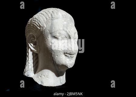 Sculpture head of Kouros isolated on black background. Istanbul Archaeology Museum, Turkey. Stock Photo