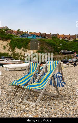 Two Deckchairs on the beach at Beer, Devon, England Stock Photo