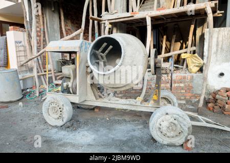 A diesel generator-based concrete mixture machine on a construction site in Uttarakhand India. Stock Photo