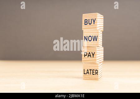 Buy Now Pay Later words on stacked wooden blocks. Copy space Stock Photo