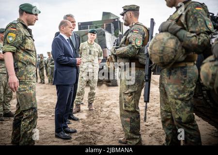 Pabrade, Lithuania. 07th June, 2022. German Chancellor Olaf Scholz (SPD), alongside Daniel Andrä, Bundeswehr Commander of the NATO Enhanced Forward Presence Battle Group (eFP Battalion) and Gitanas Nauseda, President of Lithuania, visits Camp Adrian Rohn where the more than 1000 Bundeswehr soldiers are stationed. He pledged additional military support to Lithuania to defend against a possible Russian attack. Credit: Michael Kappeler/dpa/Alamy Live News Stock Photo