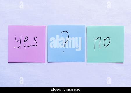 top view of cards with yes and no words near question mark on violet background Stock Photo