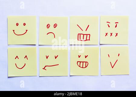top view of sticky notes with positive and negative smileys on white background Stock Photo