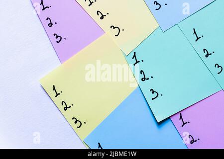 top view of multicolored sticky notes with numbers on white background Stock Photo