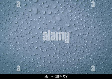 The concept of raindrops falling on gray background Abstract wet grey blue surface with bubbles on the surface Stock Photo