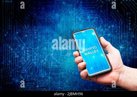 man holding a smartphone with a crypto wallet on screen Stock Photo