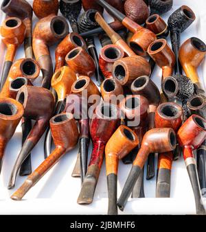 Used smoking pipes sale on a white background. Close-up Stock Photo