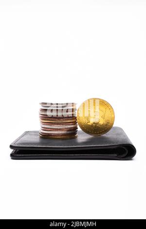 KYIV, UKRAINE - APRIL 26, 2022: Close up view of different bitcoins on wallet on white background Stock Photo