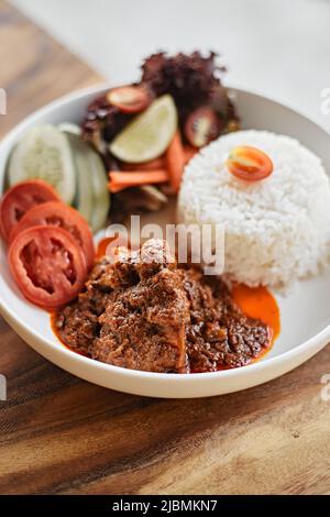 boiled spicy pork belly in curry soup or Hang leh Thai northern style food on plate Stock Photo