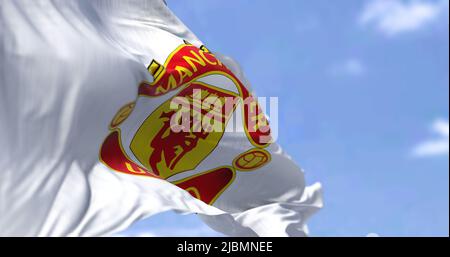 Manchester, UK, May 2022: The flag of Manchester United waving in the wind on a clear day. Manchester United is a professional football club based in