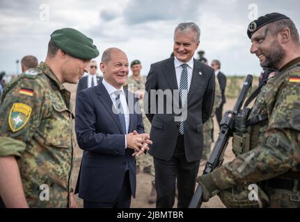 Pabrade, Lithuania. 07th June, 2022. German Chancellor Olaf Scholz (SPD), alongside Daniel Andrä, Bundeswehr Commander of the NATO Enhanced Forward Presence Battle Group (eFP Battalion) and Gitanas Nauseda, President of Lithuania, visits Camp Adrian Rohn where the more than 1000 Bundeswehr soldiers are stationed. He pledged additional military support to Lithuania to defend against a possible Russian attack. Credit: Michael Kappeler/dpa/Alamy Live News Stock Photo