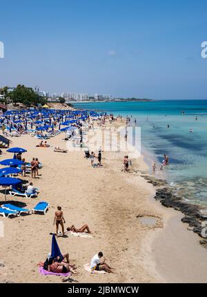 Tourist people enjoying summer vacations, relaxing, sunbathe swimming. Protaras fig tree bay Cyprus Stock Photo