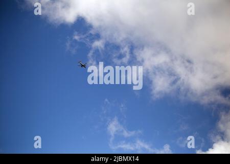 London, England, May 24th 2022, a British Airways flight seen against blue cloudy skies over London. Stock Photo