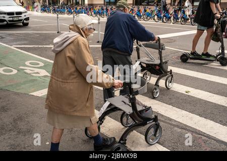 An elderly couple crosses an intersection in Chelsea in New York on Saturday, May 28, 2022.  (© Richard B. Levine) Stock Photo